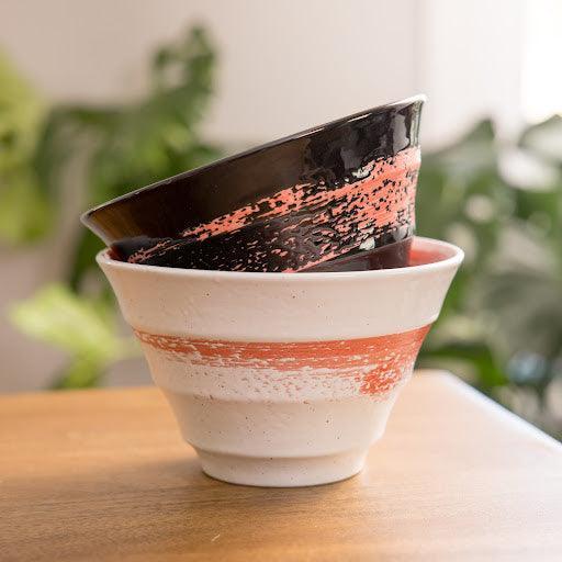 Red swirl white ceramic ramen bowl featuring bold red swirl pattern perfect for ramen salads or pasta.