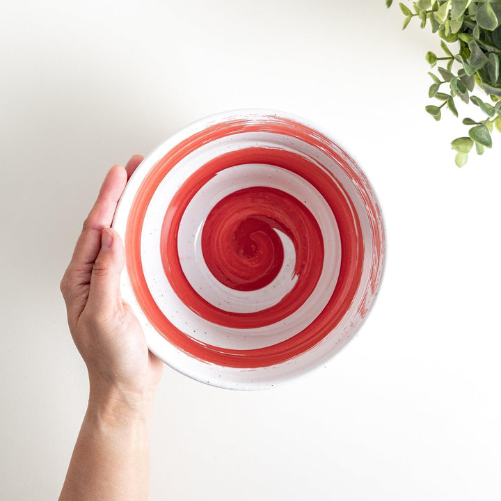 A white ramen bowl with a wide red brushstroke across its exterior.