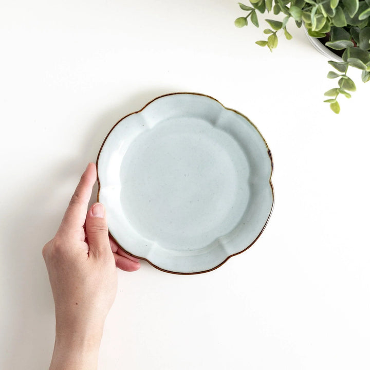 Earthy tones of olive, caramel, or off-white dessert plate, with a soft, rounded shape and subtle color variations.