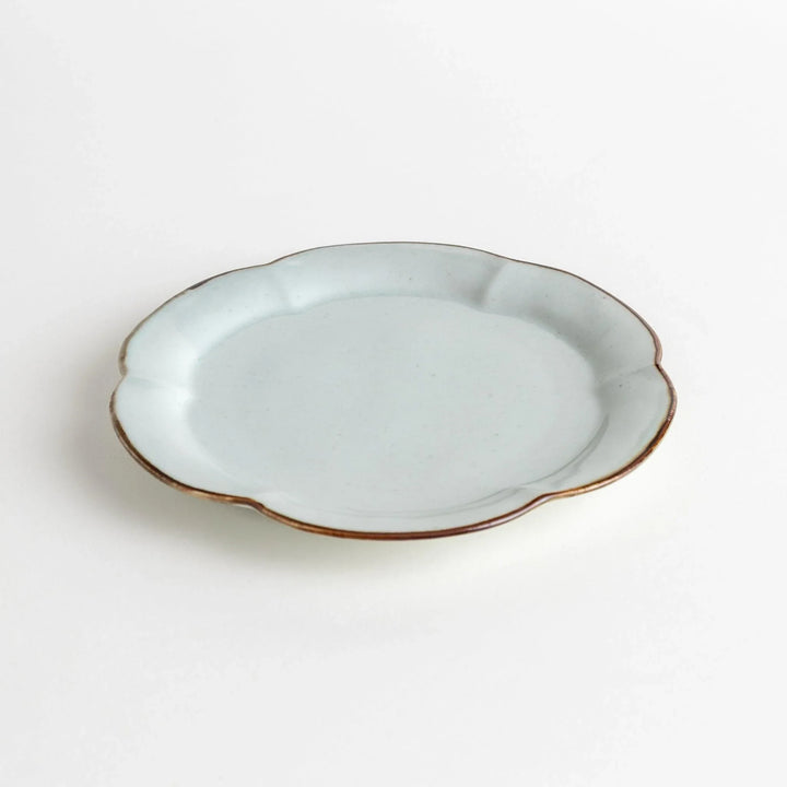 Earthy tones of olive, caramel, or off-white dessert plate, with a soft, rounded shape and subtle color variations.