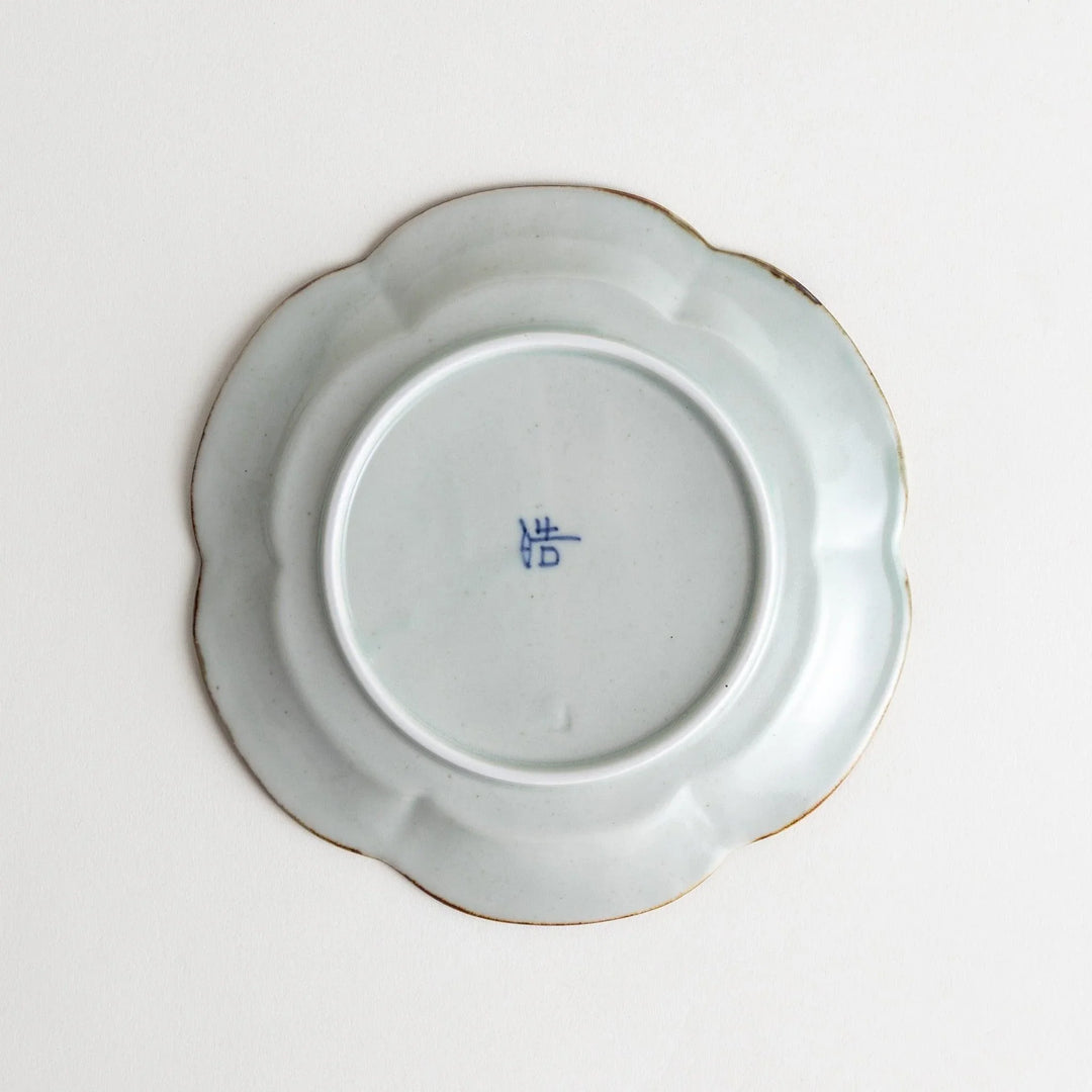 Earthy tones of olive, caramel, or off-white dessert plate, with a soft, rounded shape and subtle color variations.