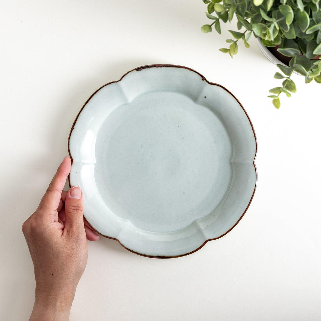 Earthy tones of olive, caramel, or off-white salad plate, with a soft, rounded shape and subtle color variations.