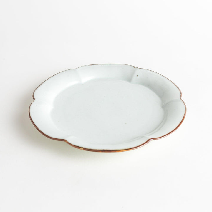 Earthy tones of olive, caramel, or off-white salad plate, with a soft, rounded shape and subtle color variations.