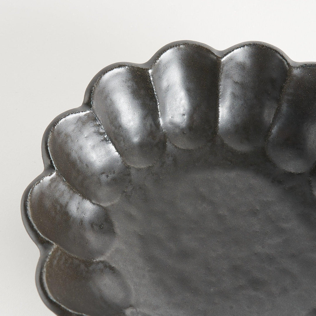 A white ceramic pasta bowl with a scalloped flower-petal design.