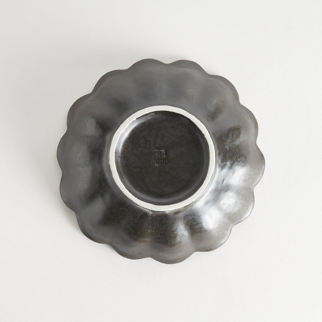 A white ceramic pasta bowl with a scalloped flower-petal design.