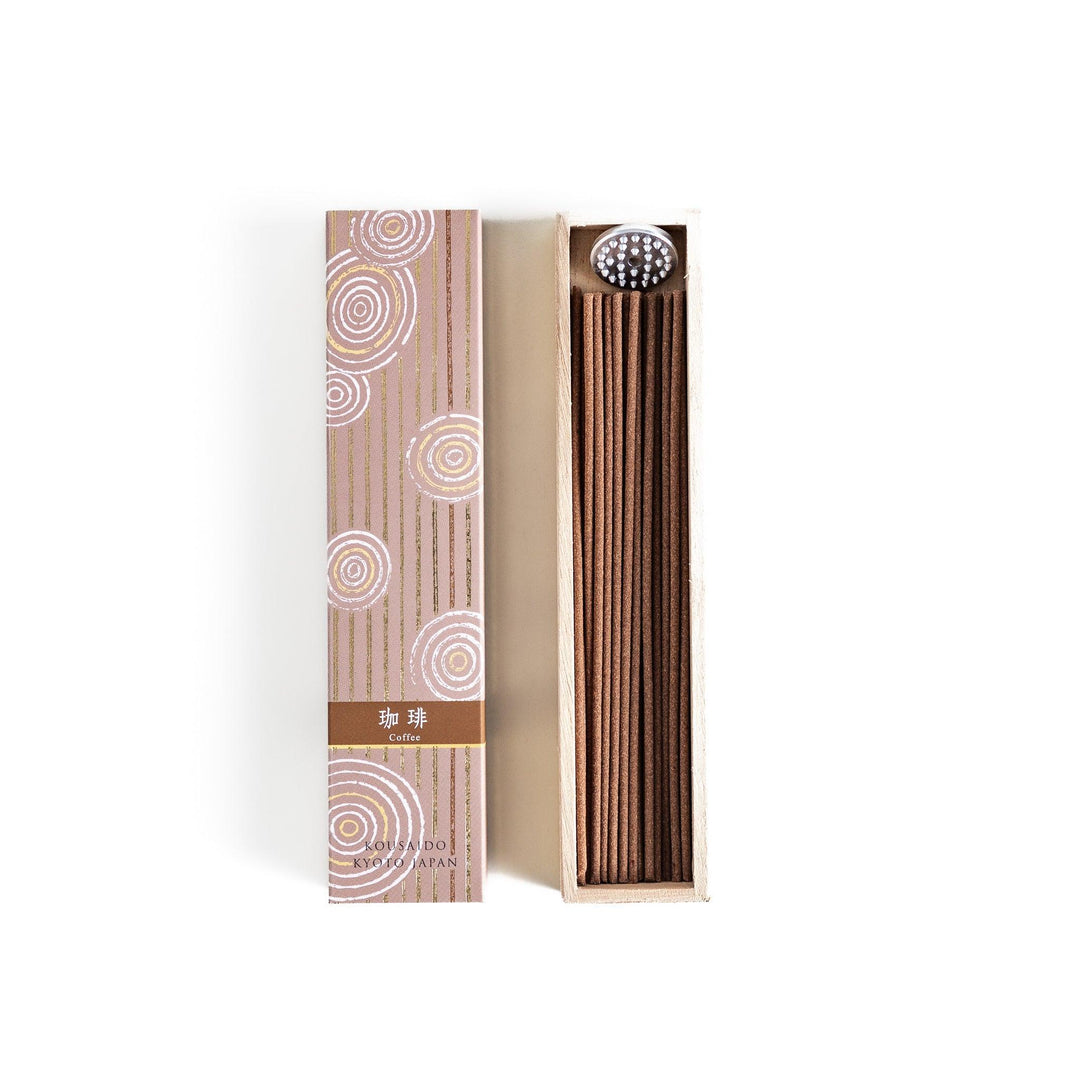 Brown incense sticks in a wooden box with beige packaging and white circular patterns evoking coffee aroma.
