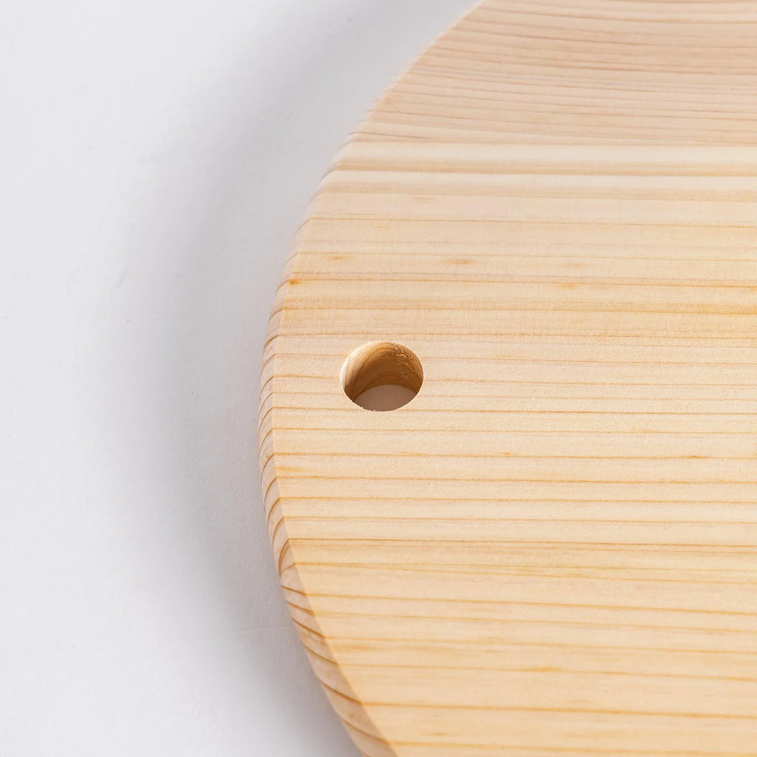 Close-up of the hole in the round Hinoki cutting board.