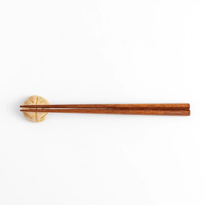 Rustic bread-shaped chopstick rest, featuring a natural, earthy design with a leaf-like scoring on top.