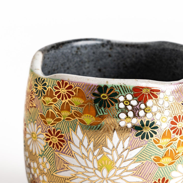 Gray ceramic mug with floral pattern in gold and pastels speckled glaze and comfortable handle design.