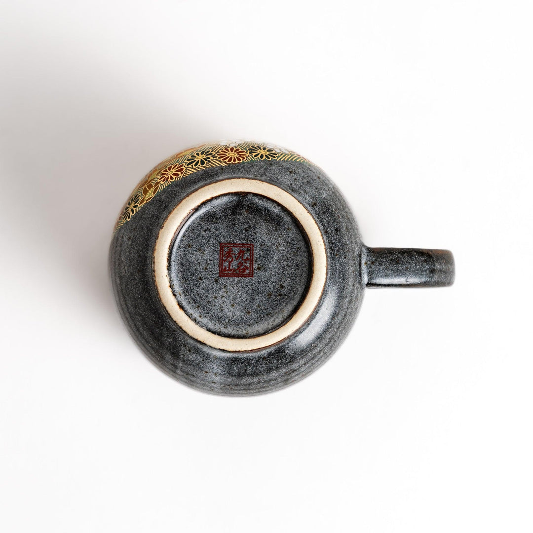 Gray ceramic mug with floral pattern in gold and pastels speckled glaze and comfortable handle design.