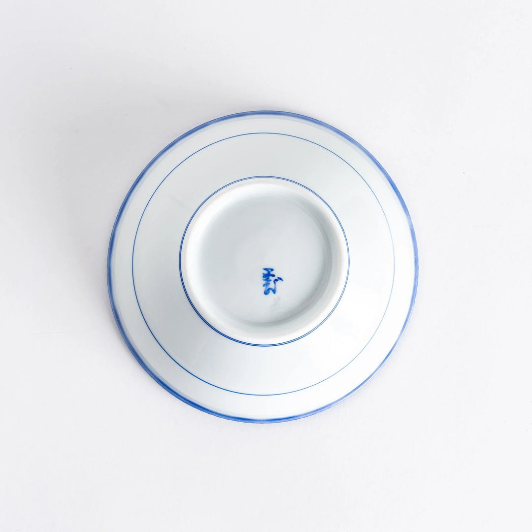 Underside view of the cereal bowl showing the smooth base with fine detailing and manufacturer marks.