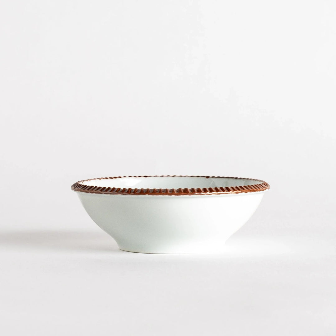 A round white dessert bowl with a rustic scallop-edged border. The border comes in blue, brown, and olive.