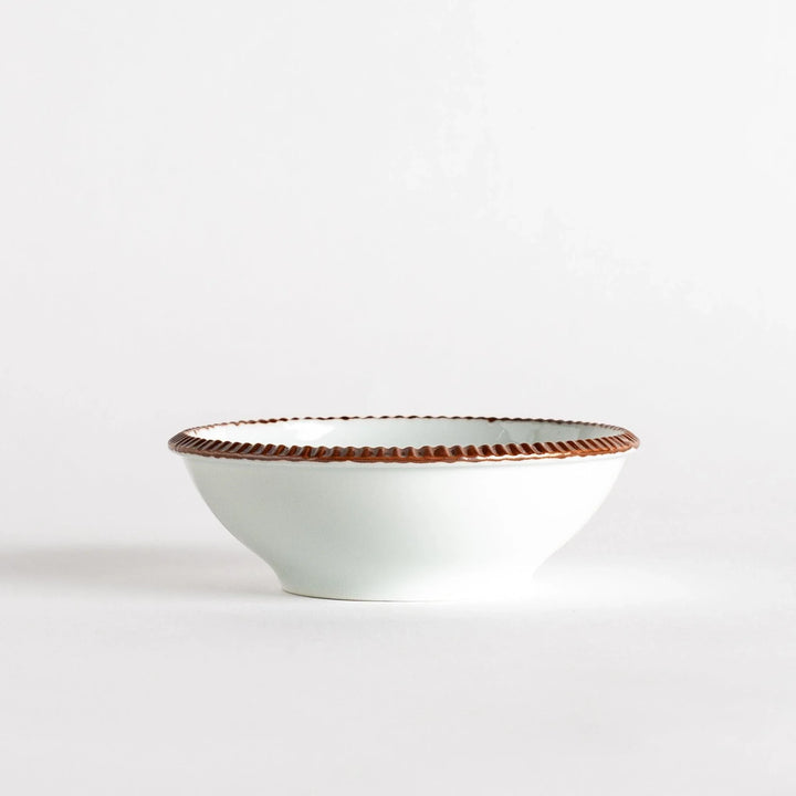 A round white dessert bowl with a rustic scallop-edged border. The border comes in blue, brown, and olive.