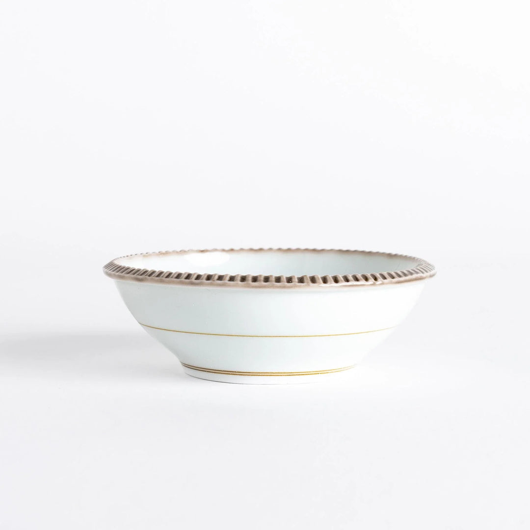 A round white dessert bowl with a rustic scallop-edged border. The border comes in blue, brown, and olive.