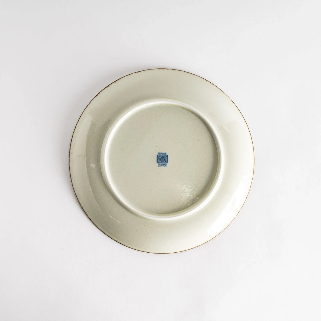 A round dinner plate featuring a striking pattern of blue lines radiating from the center.