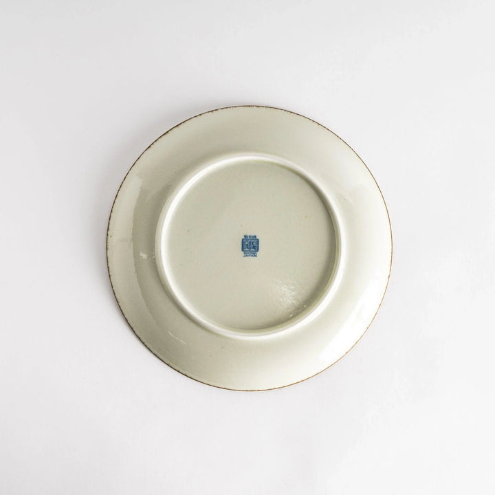 A round dinner plate featuring a striking pattern of blue lines radiating from the center.