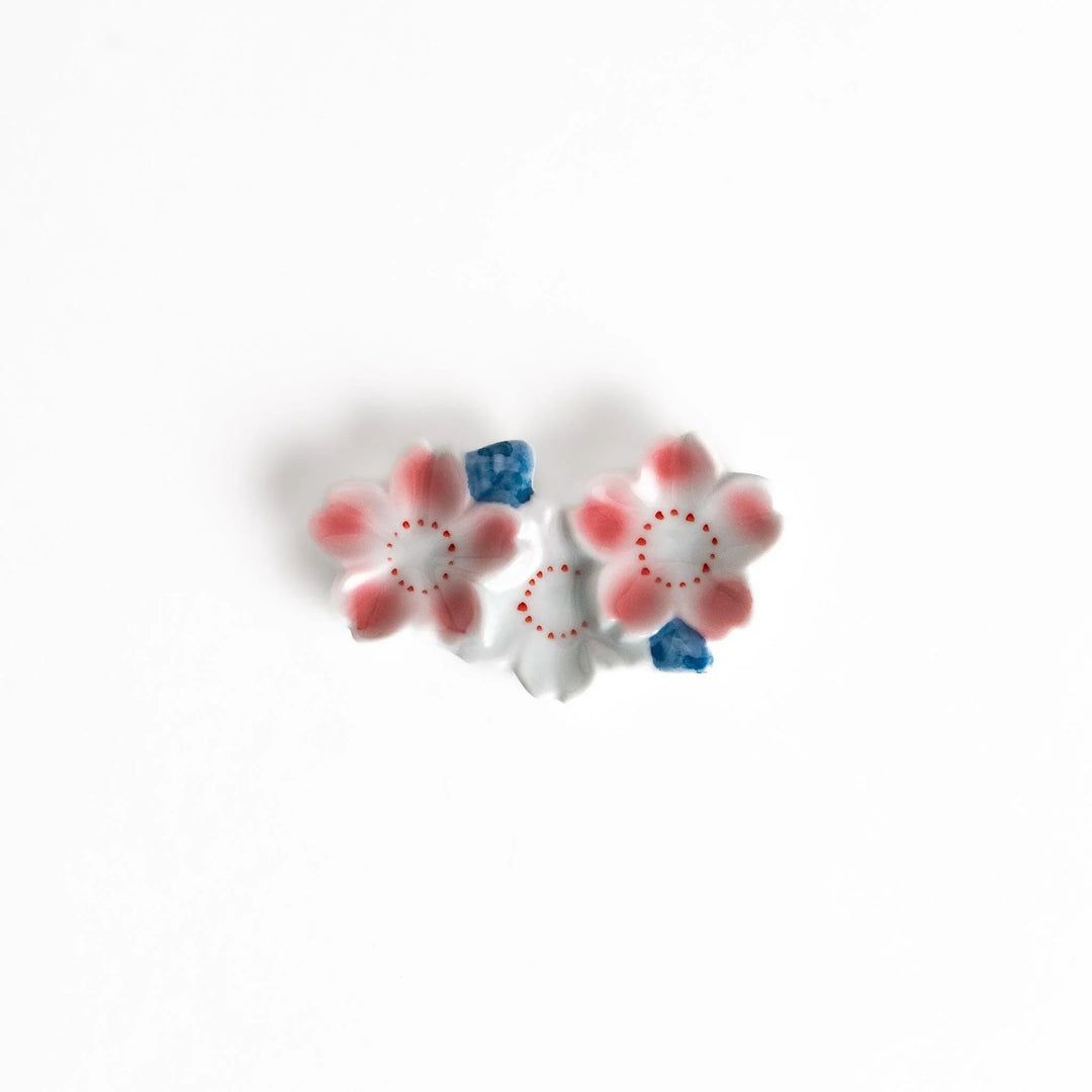 Sakura blossom chopstick rest with pink flowers and blue accents adding elegant spring charm to dining.