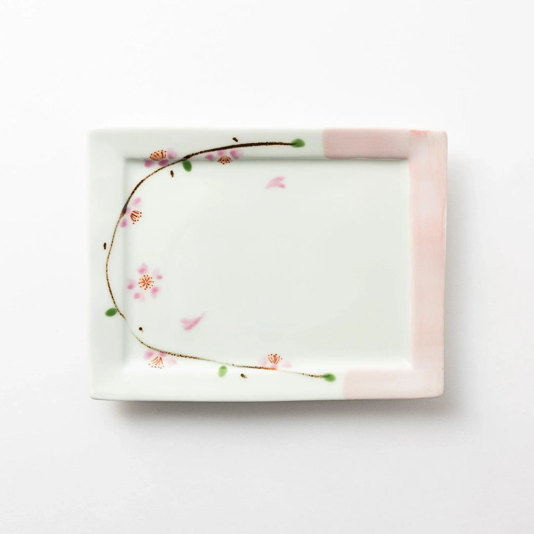 Rectangular dessert plate with a delicate cherry blossom design, featuring soft pink and green accents along the edges.