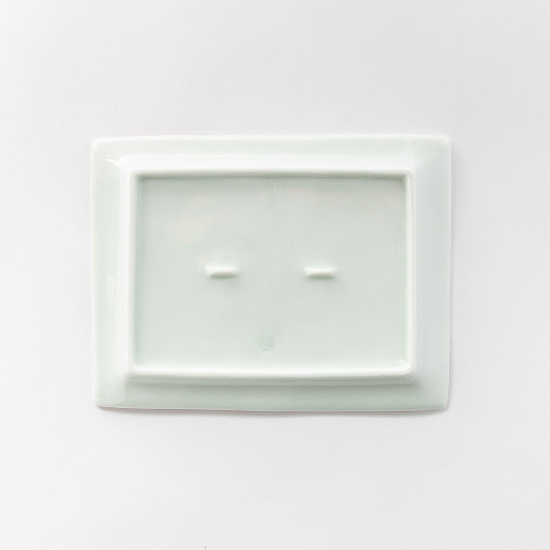 Underneath view of the dessert plate, showing the smooth, white porcelain base.