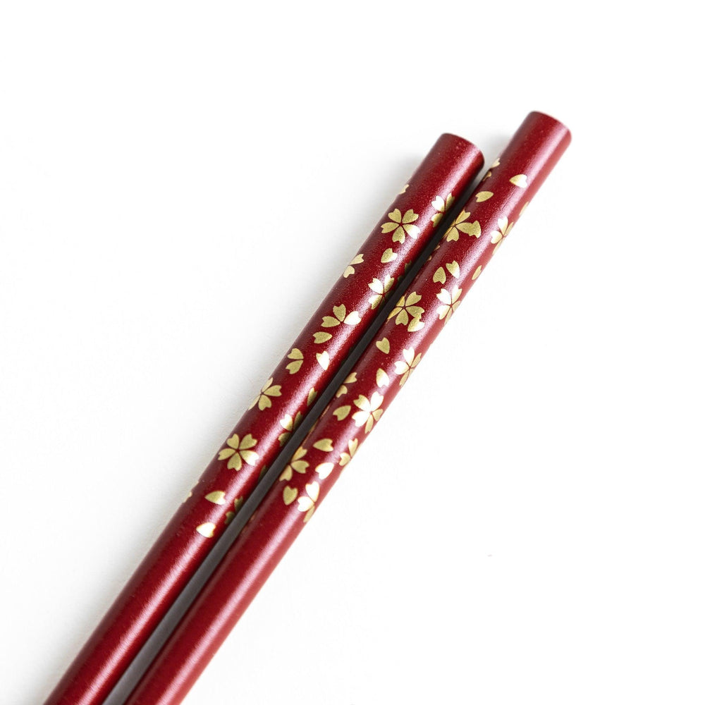Red lacquer chopsticks with sakura patterns. Available in black or red.