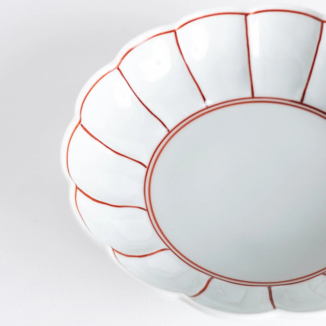 A small round dessert bowl with a delicate blue chrysanthemum pattern and scalloped edges.