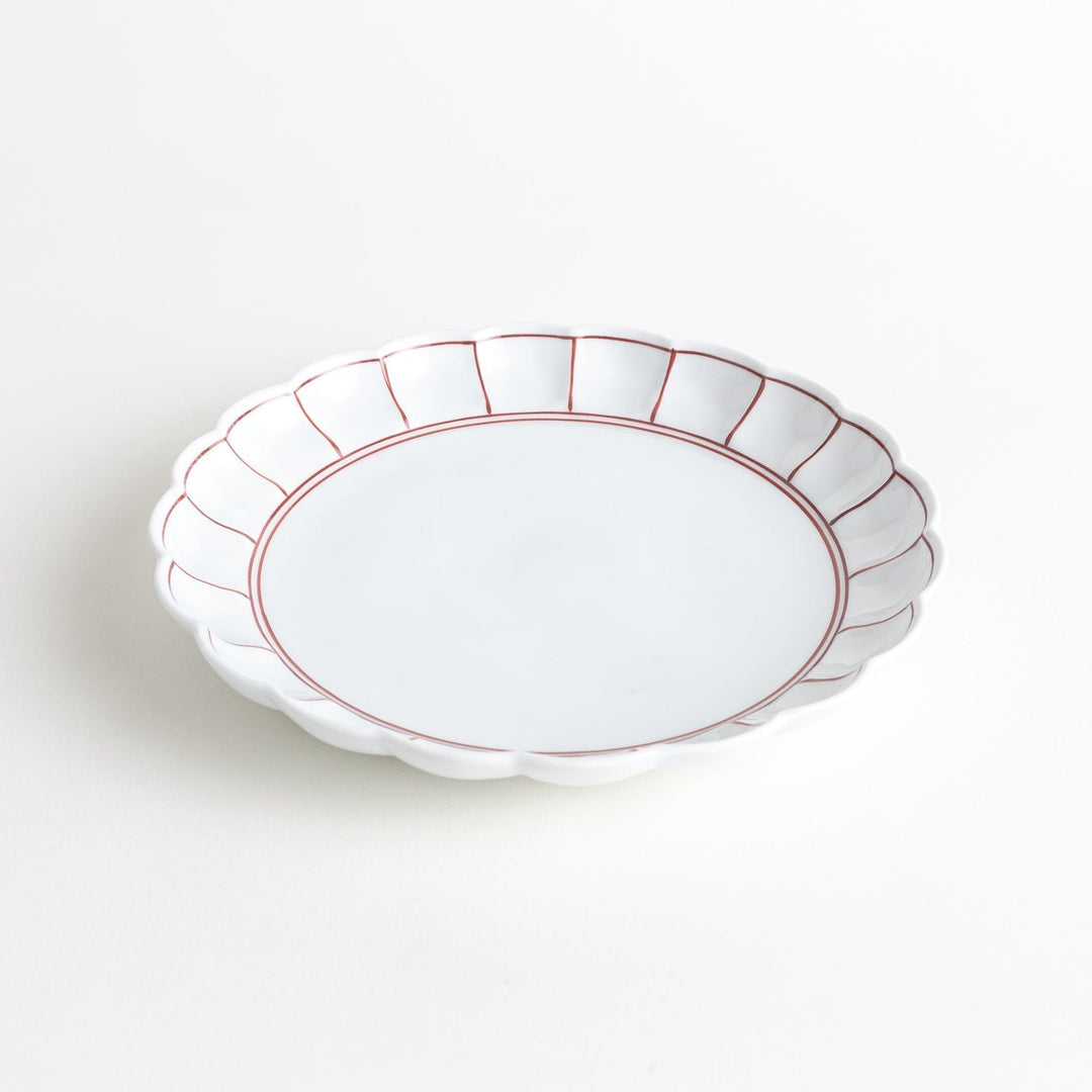 White salad plate with scalloped edges, outlined in a thin blue or red line.