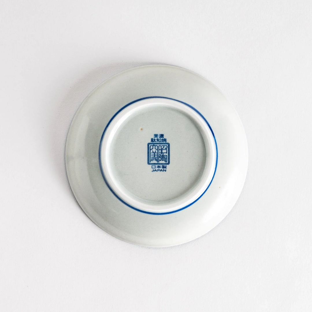 A shallow round plate with a speckled blue pattern covering the surface.