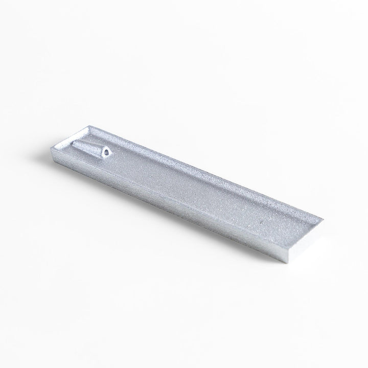 Aluminum incense holder with tray and slot design, holding incense securely and collecting falling ash.