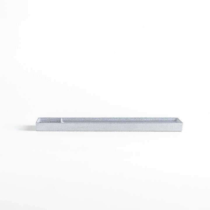 Aluminum incense holder with tray and slot design, holding incense securely and collecting falling ash.