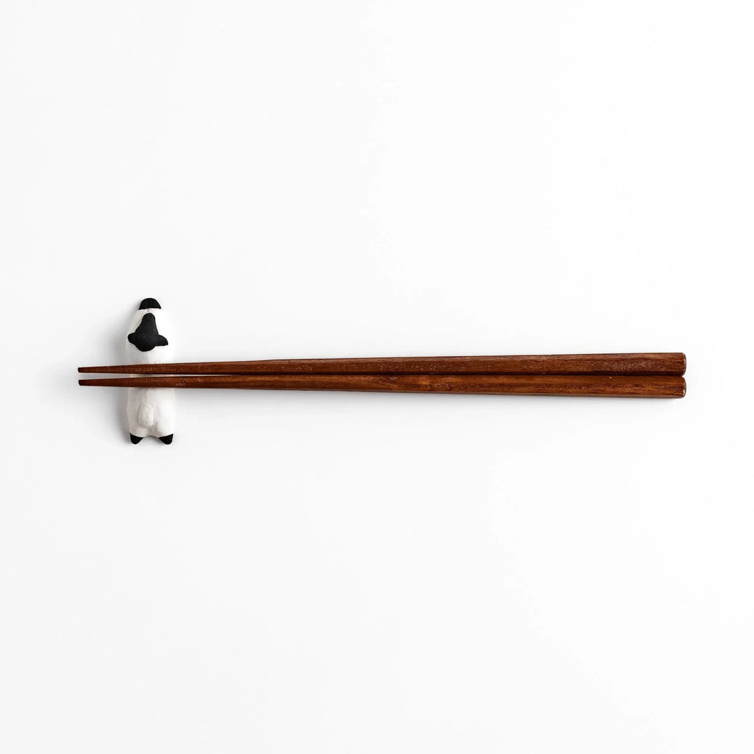 Sleeping sheep chopstick rest in black and white, crafted with a minimalist design for a playful touch.
