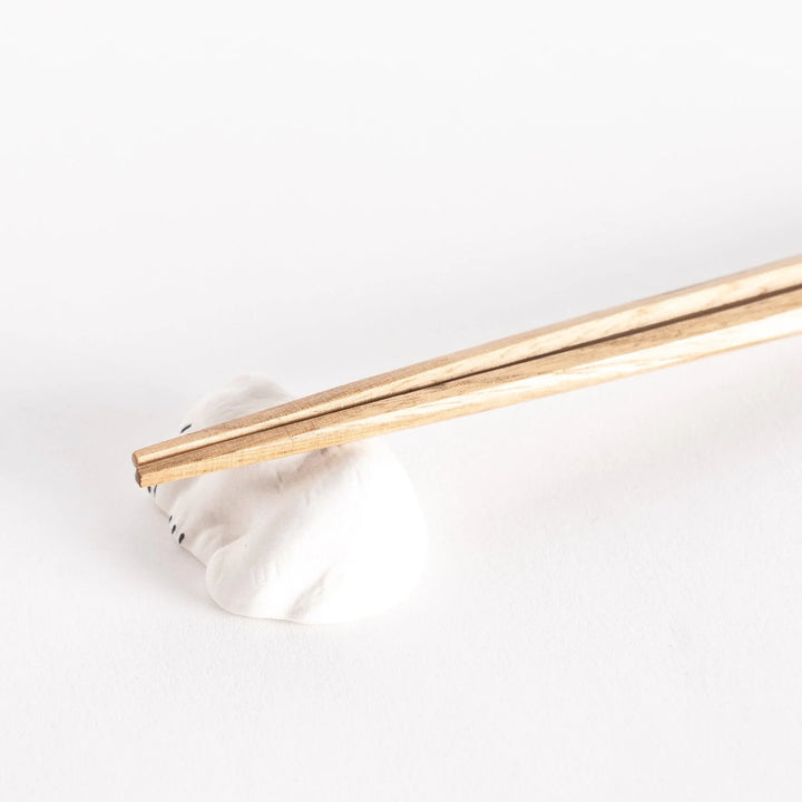 Close-up of the polar bear chopstick rest, showcasing its peaceful sleeping posture and detailed features.