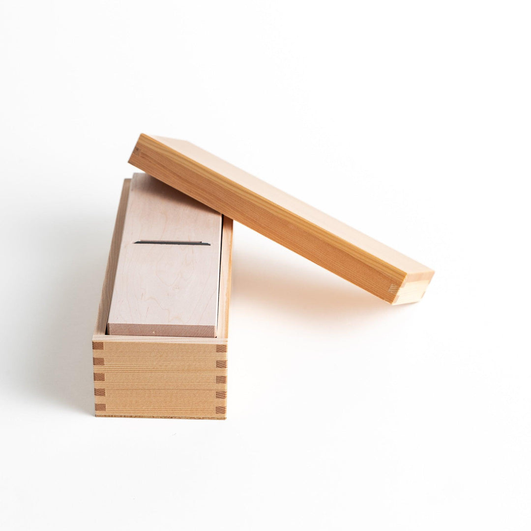 Small wooden katsuobushi shaver box with sliding drawer and lid and colorful Japanese artwork packaging.