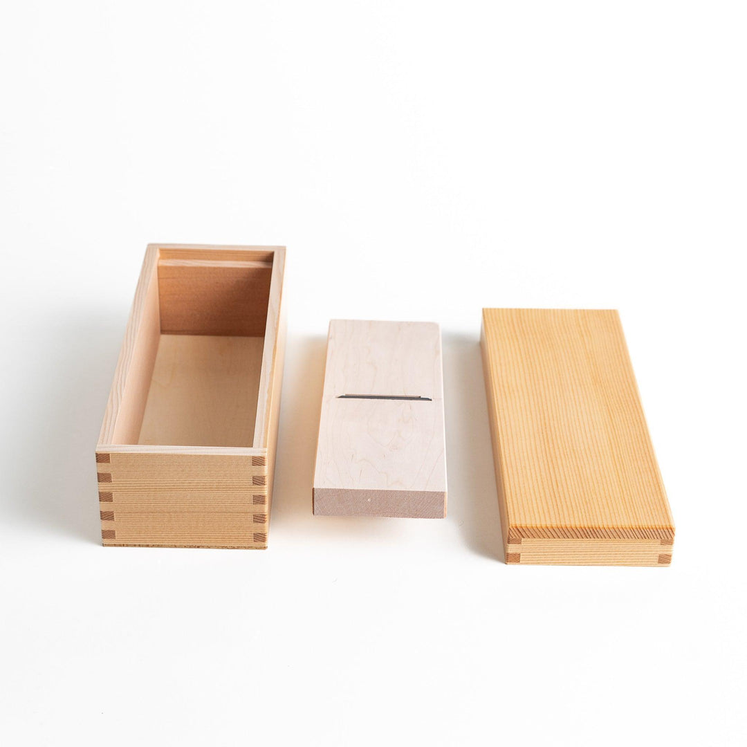 Small wooden katsuobushi shaver box with sliding drawer and lid and colorful Japanese artwork packaging.
