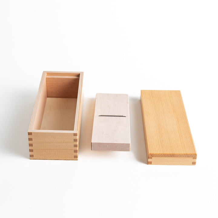 Small wooden katsuobushi shaver box with sliding drawer and lid and colorful Japanese artwork packaging.