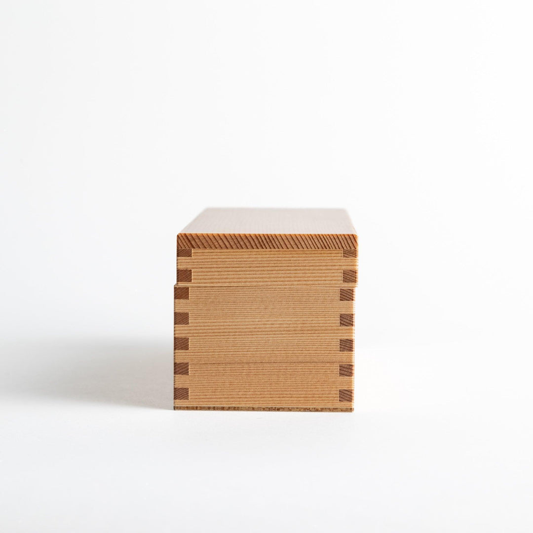 Small wooden katsuobushi shaver box with sliding drawer and lid and colorful Japanese artwork packaging.