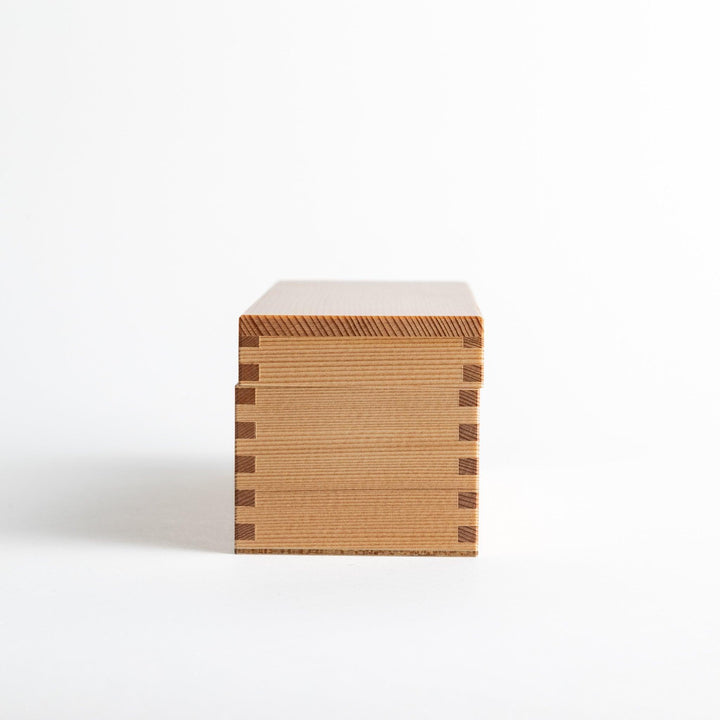 Small wooden katsuobushi shaver box with sliding drawer and lid and colorful Japanese artwork packaging.