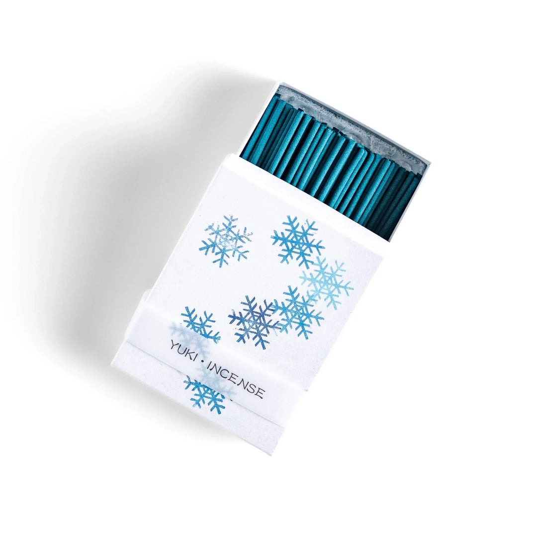 Incense with brown sticks in a pine tree design box offering a fresh woody fragrance reminiscent of evergreen forests.