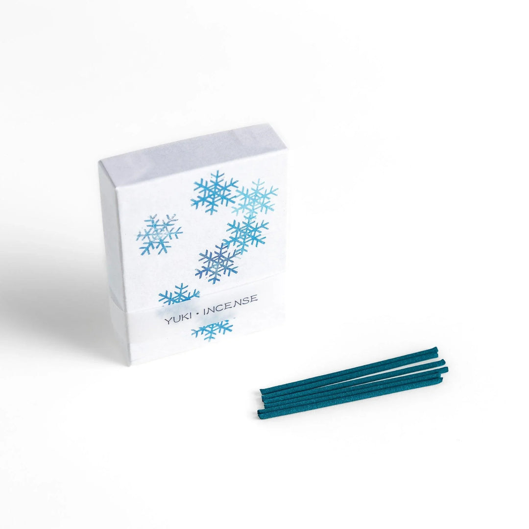 Incense with brown sticks in a pine tree design box offering a fresh woody fragrance reminiscent of evergreen forests.