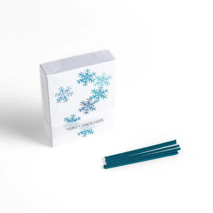 Incense with brown sticks in a pine tree design box offering a fresh woody fragrance reminiscent of evergreen forests.