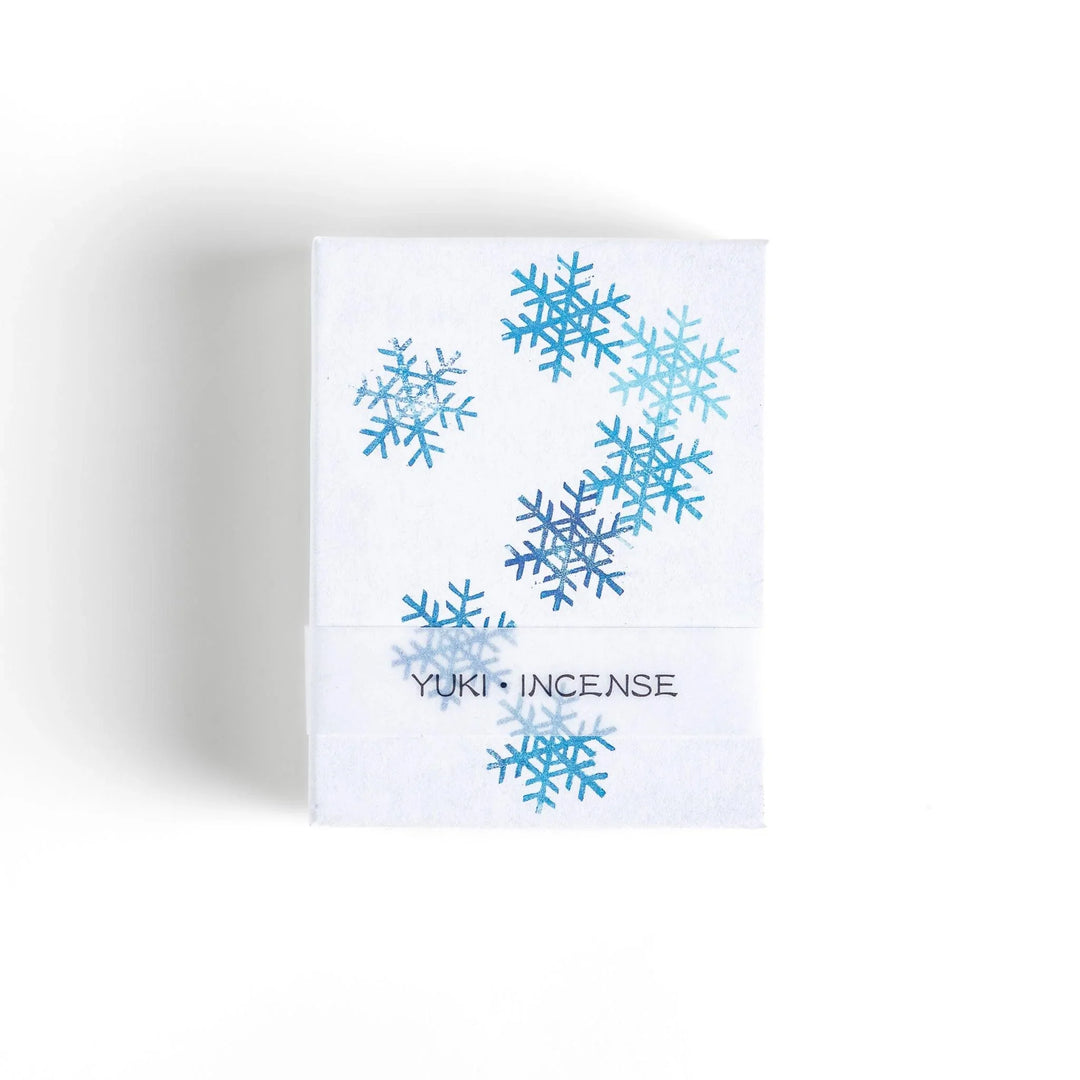 Incense with brown sticks in a pine tree design box offering a fresh woody fragrance reminiscent of evergreen forests.