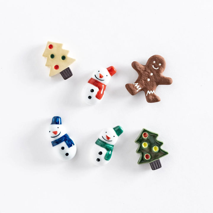 Festive holiday chopstick rests shaped like snowmen Christmas trees and gingerbread cookies adding cheerful touch.