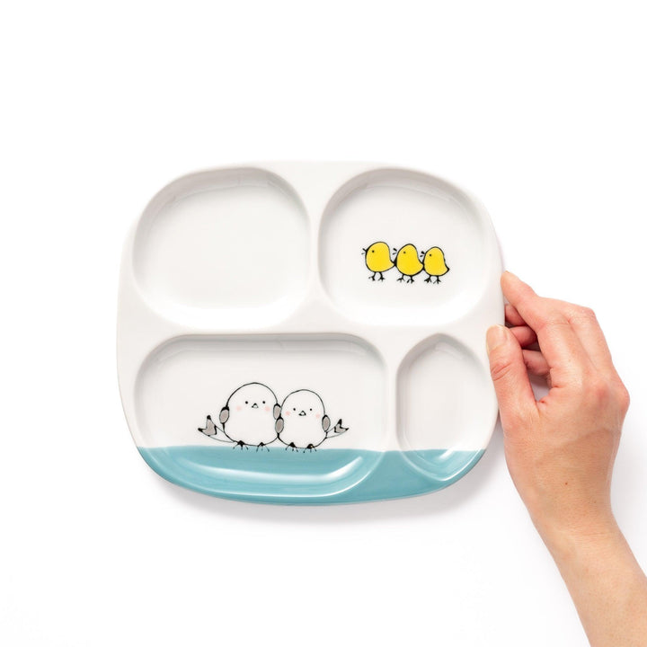Kids’ plate featuring two snowbirds and three yellow chicks with blue accents, perfect for cheerful mealtime.
