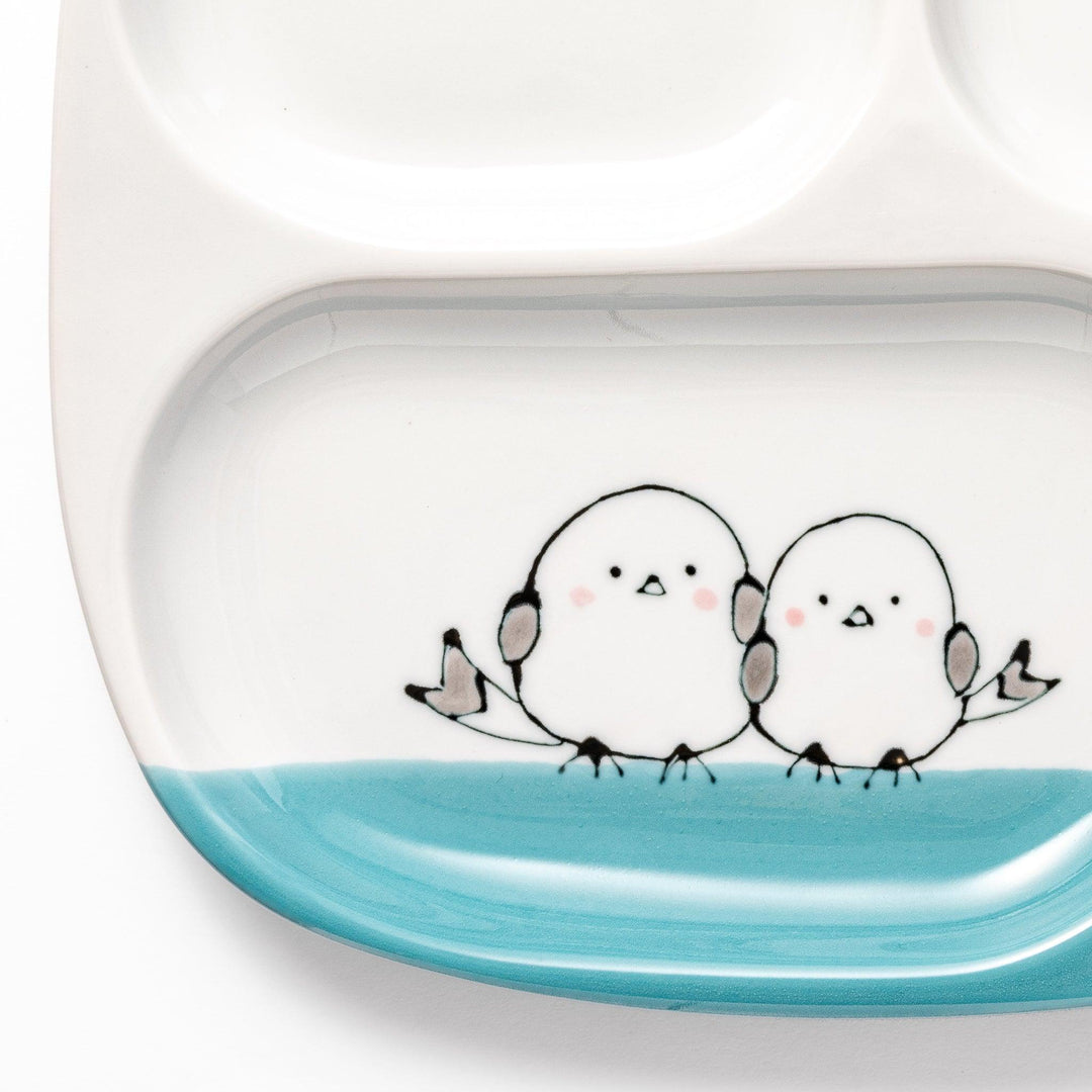 Kids’ plate featuring two snowbirds and three yellow chicks with blue accents, perfect for cheerful mealtime.