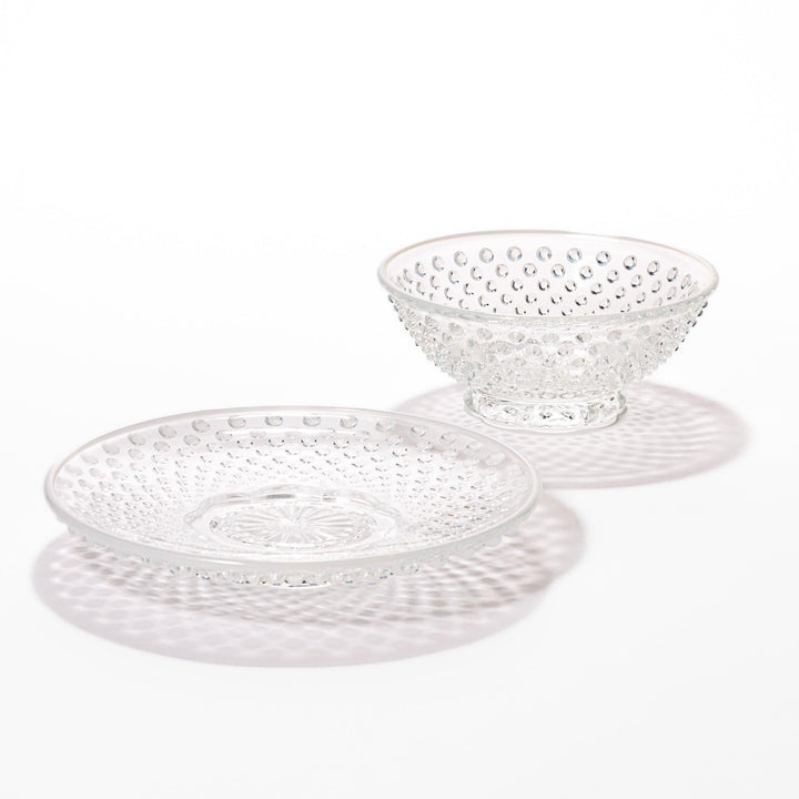 Clear glass dessert bowl and saucer with raised dots and starburst base, perfect for elegant desserts or fruit.