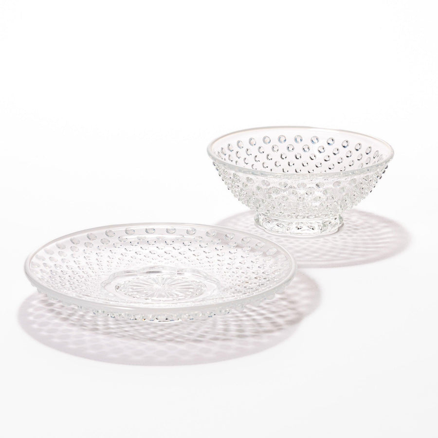 Clear glass dessert bowl and saucer with raised dots and starburst base, perfect for elegant desserts or fruit.
