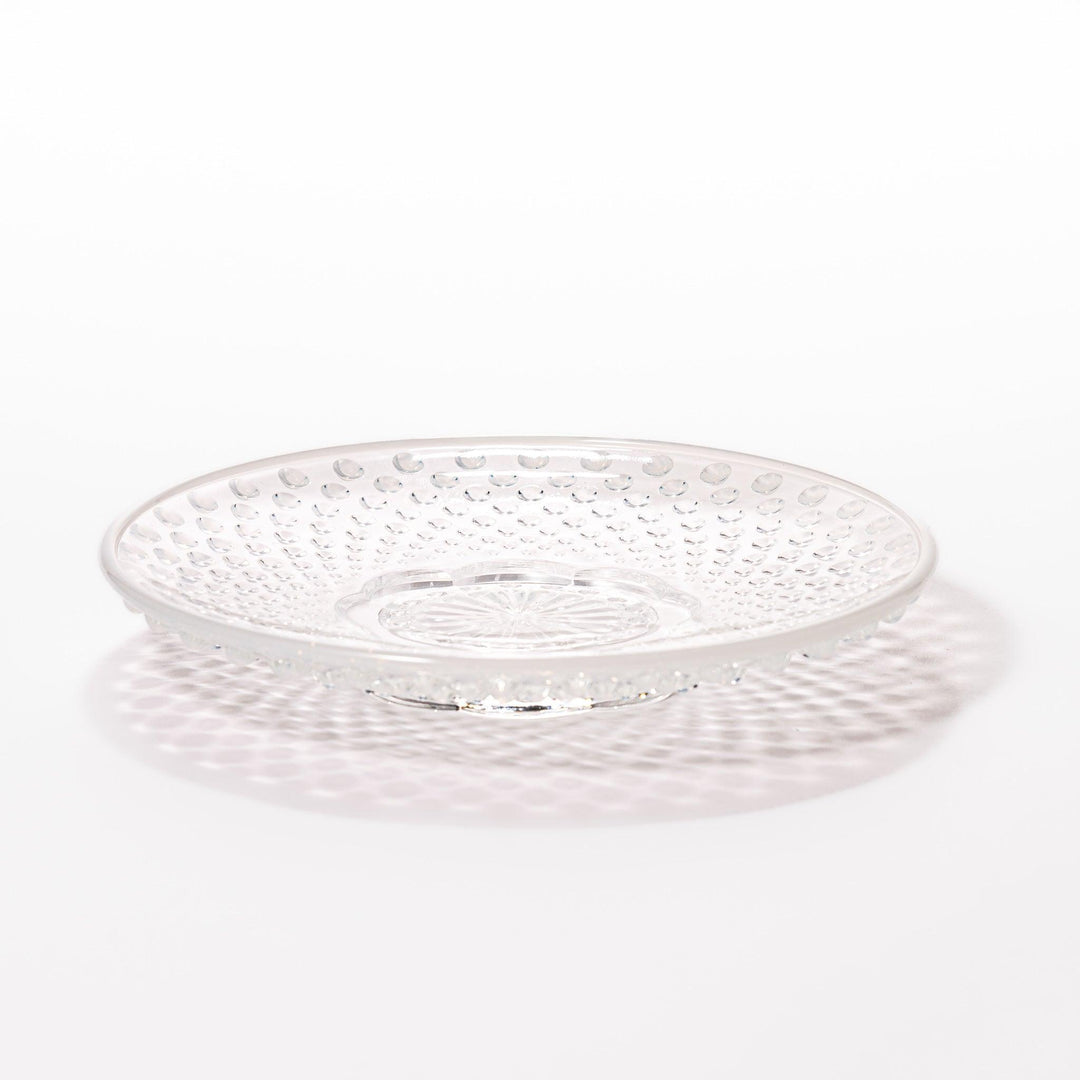 Clear glass dessert bowl and saucer with raised dots and starburst base, perfect for elegant desserts or fruit.