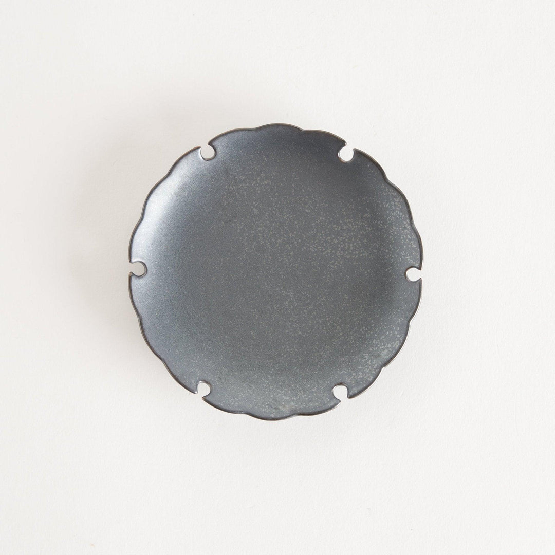 Ceramic sauce dishes with scalloped edges, available in black and white.