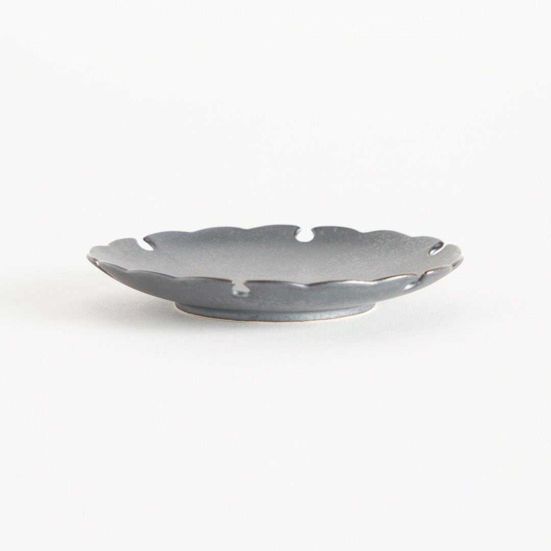 Ceramic sauce dishes with scalloped edges, available in black and white.