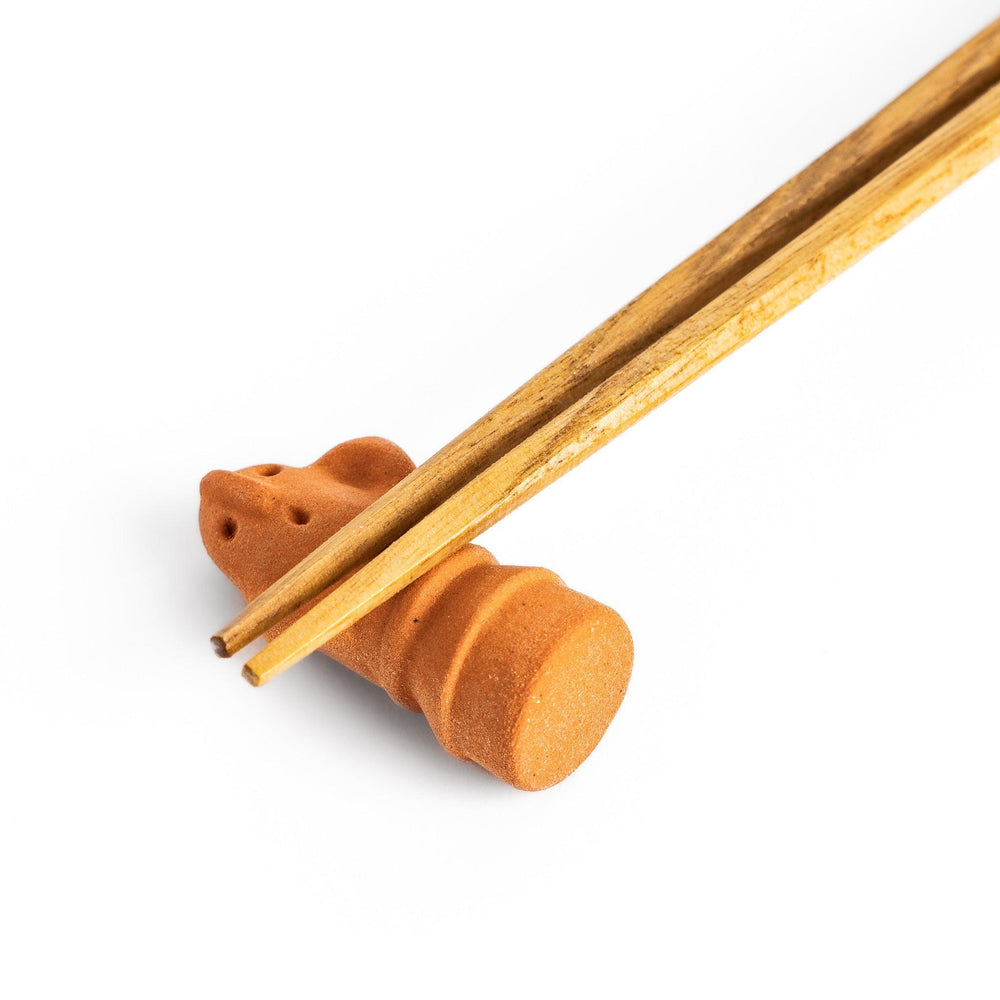 Guardian figure-shaped chopstick rest, bringing a whimsical and protective charm to your table setting.