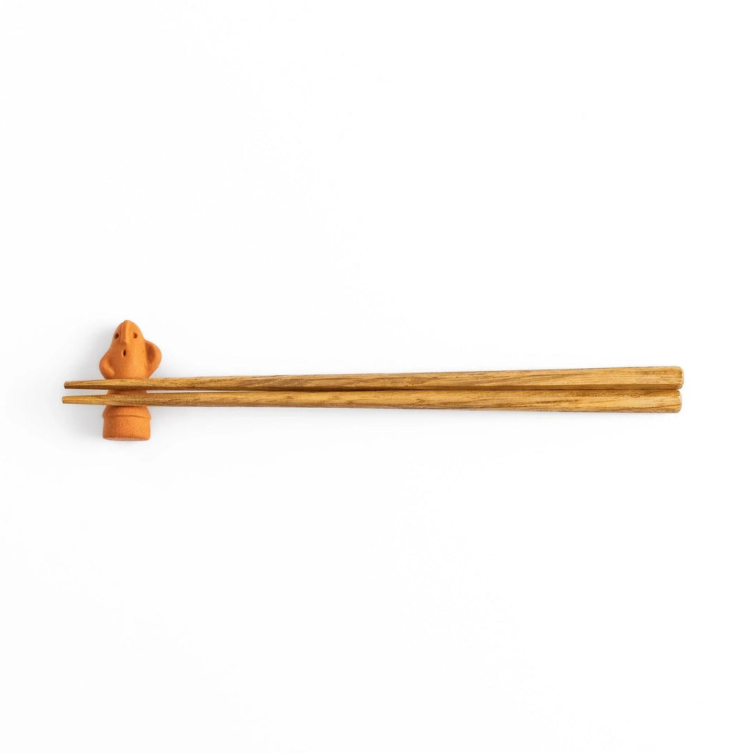 Guardian figure-shaped chopstick rest, bringing a whimsical and protective charm to your table setting.